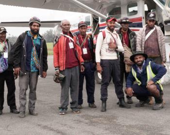 Passengers standing beside a plane