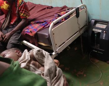 Mougulu health centre: breast feeding baby attached on oxygen concentrator 