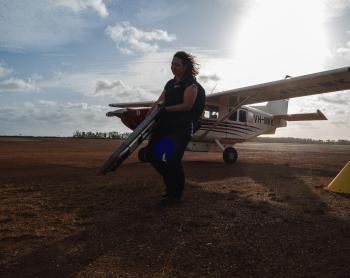 MAF staff carrying medical equipment from aircraft