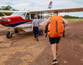 Physiotherapist and pilot walking toward aircraft