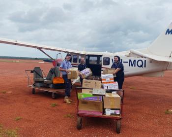 MAF staff loading grocery supplies onto plane