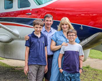 The Symmonds family in front of a C208 MAF plane.