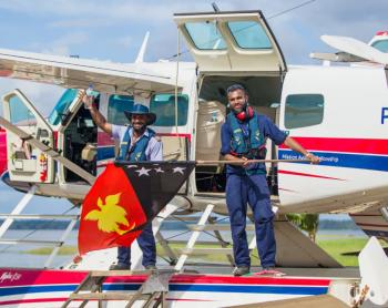 Joseph Tua and Titus Oaeke celebrate Independence on the float plane floats