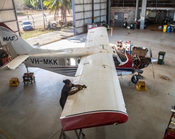 Engineer working on an aircraft in a hangar