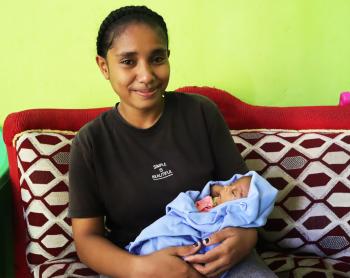 A woman holding a baby