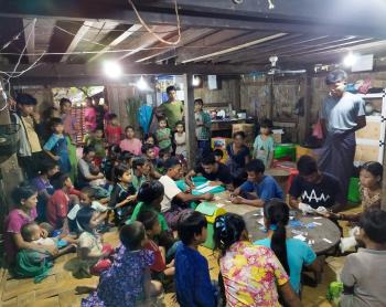 A group of people getting medical screening under electric light