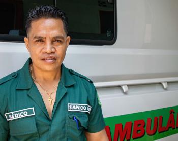 A medic stands next to an ambulance
