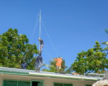 MAF Technologies technicians install HF radio, solar panels, and an inverter at Han Clinic, Carteret Islands
