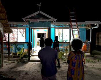 The successful installation of solar lighting at the clinic is revealed as the lights shine brightly at night