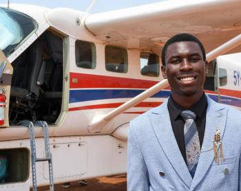 Daniel Peni poses for a picture after landing at Kajjansi Airstrip, Uganda