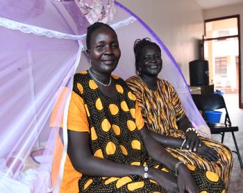 Elizabeth and Ayaar sitting on the bed at the Reconciliation Hospital