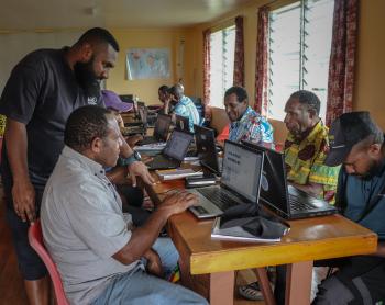 Kowara Bell offers guidance to a participant during basic computer training.