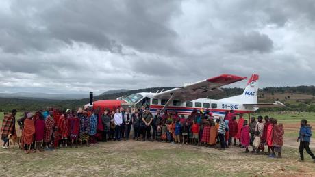 A team of UK based volunteers and the RedTribe officials posing with the locals at an airstrip in Enairebuk
