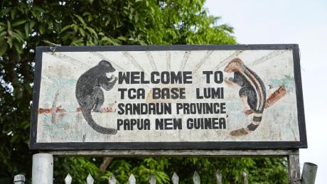 signboard of the entrance to the Tenkile Conservation Alliance base at Lumi