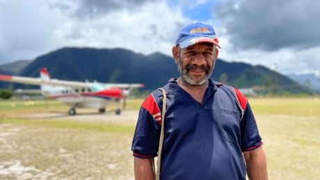 Ps Benard Nohsarin in front of a MAF aircraft at Telefomin