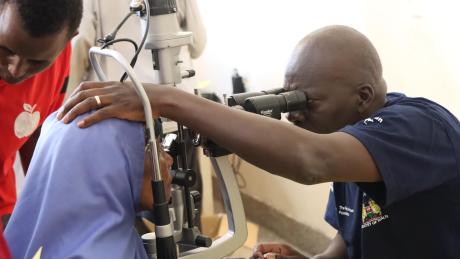 An ophthamologist screening a patient.