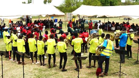 Refugees at Bidibidi settlement playing brass instruments 