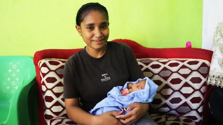 A woman holding a baby