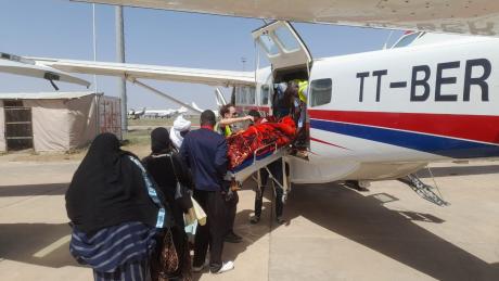 Aziza being removed from the plane