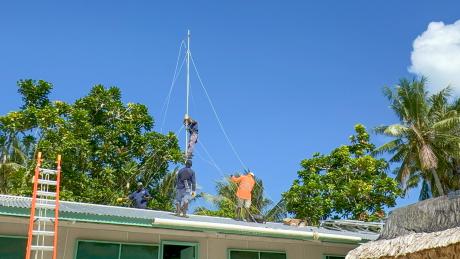 MAF Technologies technicians install HF radio, solar panels, and an inverter at Han Clinic, Carteret Islands