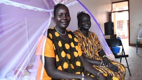 Elizabeth and Ayaar sitting on the bed at the Reconciliation Hospital