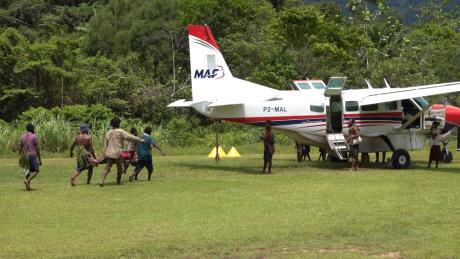 Kaiam Medevac patient being lifted unto MAF plane