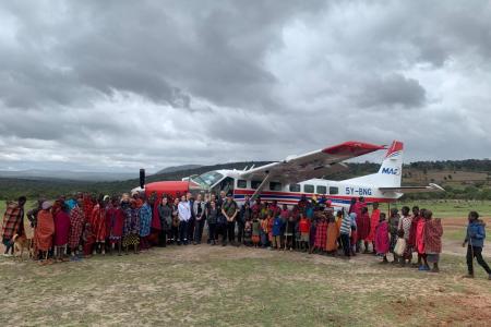A team of UK based volunteers and the RedTribe officials posing with the locals at an airstrip in Enairebuk