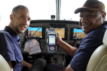 Samuel Dauth and Maro Kopi showing the new equipment while sitting in the cockpit of a C208