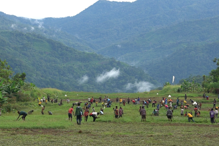 Community of Maramb cutting grass on the airstrip