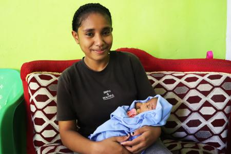 A woman holding a baby