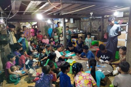 A group of people getting medical screening under electric light