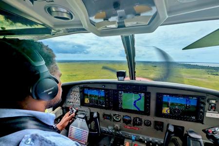Ricky Poki flying MAF Plane delivering services to the remote communities around Balimo.