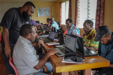 Kowara Bell offers guidance to a participant during basic computer training.