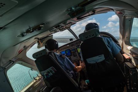 Two pilots in the cockpit of a banking aircraft