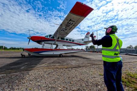 Terry Lobog guiding taxiing plane