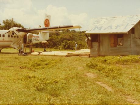 A plane at a remote outpost next to a shed