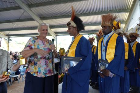 Julienne receiving a present from school founder Sally Lloyd