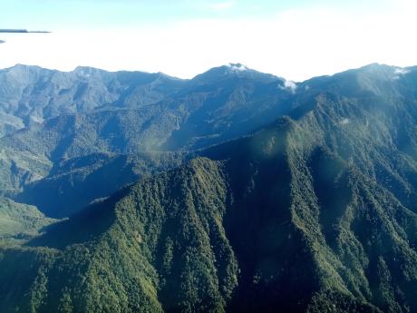 overflying the steep mountains with thick forest in the Finisterre Ranges