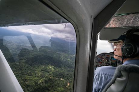 Paul looks out the window at the scenery below