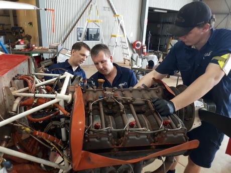 Engineers working on aircraft engine