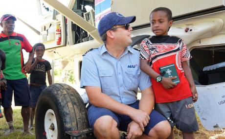 Tim Neufeld and the boy with the Bible at Simogu