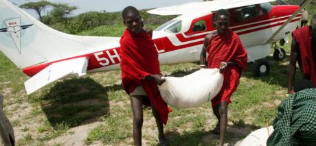 Sacks of food grain are delivered to a remote Tanzanian village during a severe drought and resulting famine which affected much of East Africa.