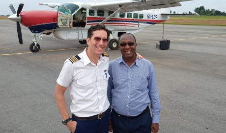 Greg Vine and Sam Sapwe standing in front of the aircraft before departure at Arua airport