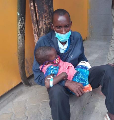 Neyeso is held by her father after they were discharged from the hospital