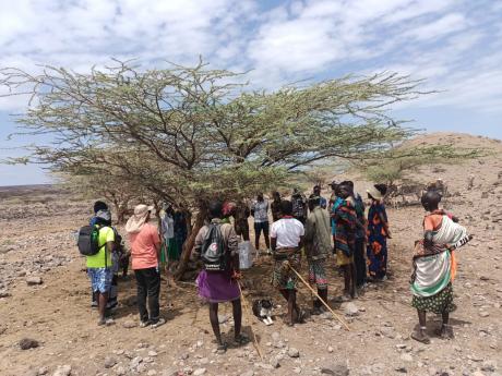 The evangelist and the locals holding prayers during the camp