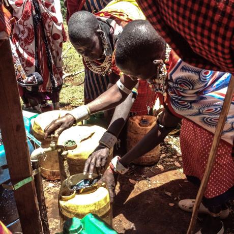 Maasai women gathered at a waterpoint to fetch drinking water.
