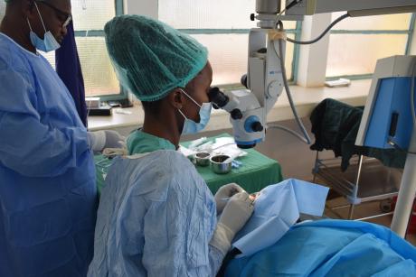 Ophthalmologists perform an eye surgery on a patient to remove cataract.