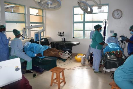 Ophthalmologists perform an eye surgery on a patient