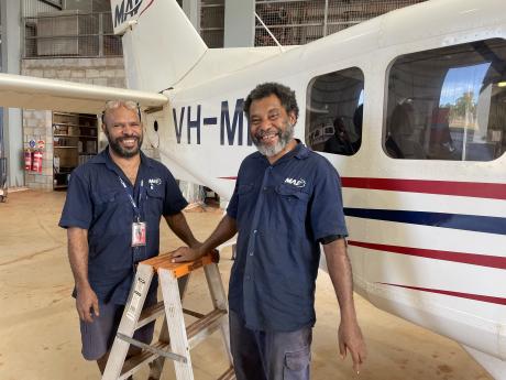 David and Francis standing, smiling, next to aircraft