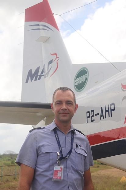 A Potrait shot of MAF PNG Pilot, Joel Rominger posing in front of a MAF SDP Plane